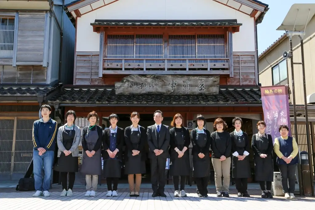 The Nakauraya staff standing outside their storefront.