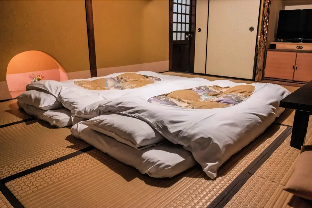 Two futon mattresses on a tatami floor.