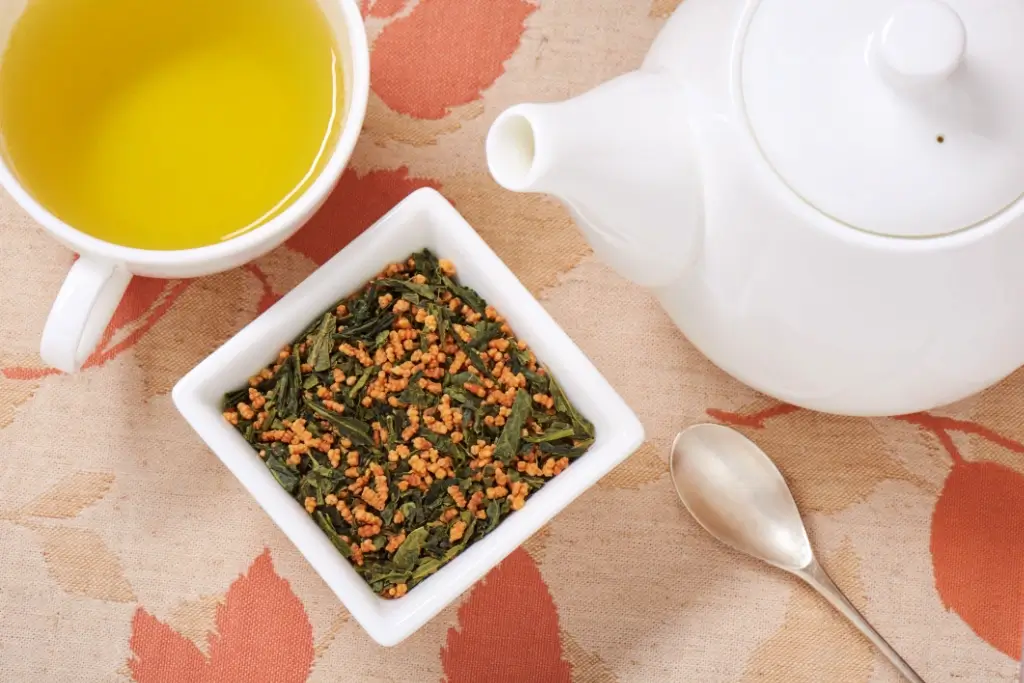 A box of genmaicha with a cup of genmaicha.