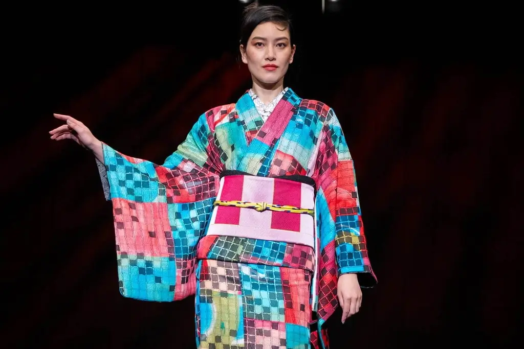 A model wearing a colorful pink, red and blue kimono by Jotaro Saito.