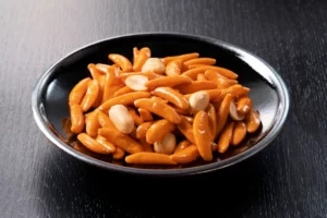 A plate of kaki no tane with buttered peanuts.