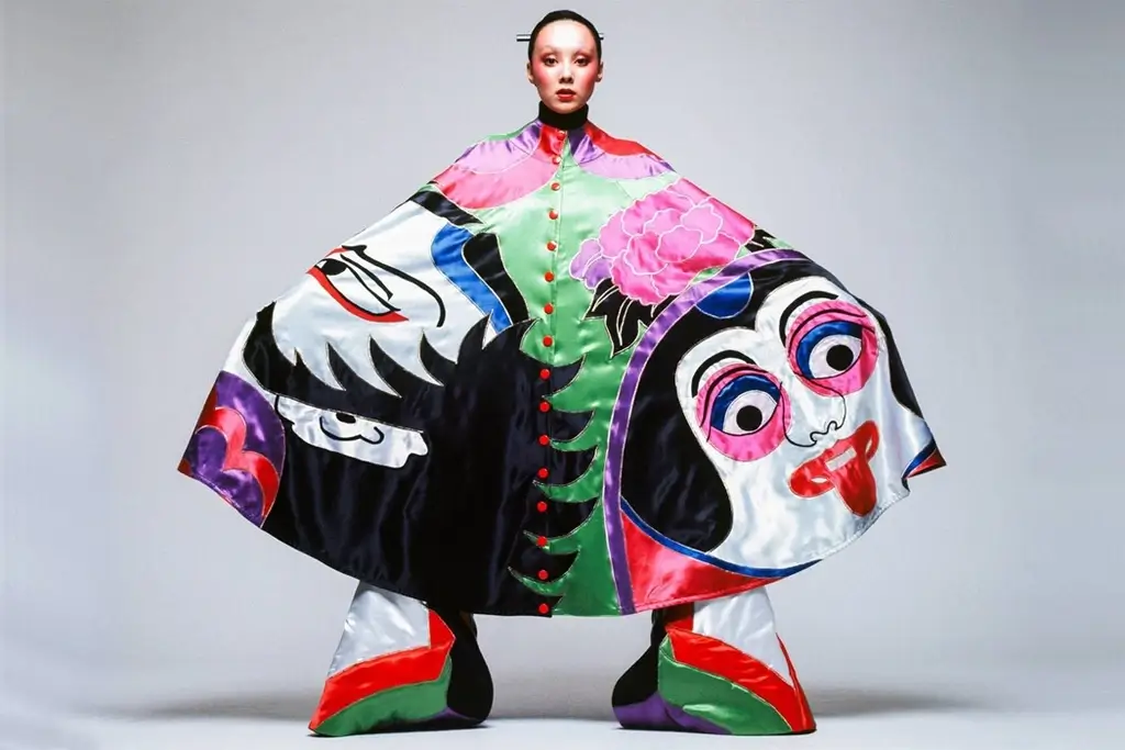 A model wearing a decorative poncho designed by Kansai Yamamoto.