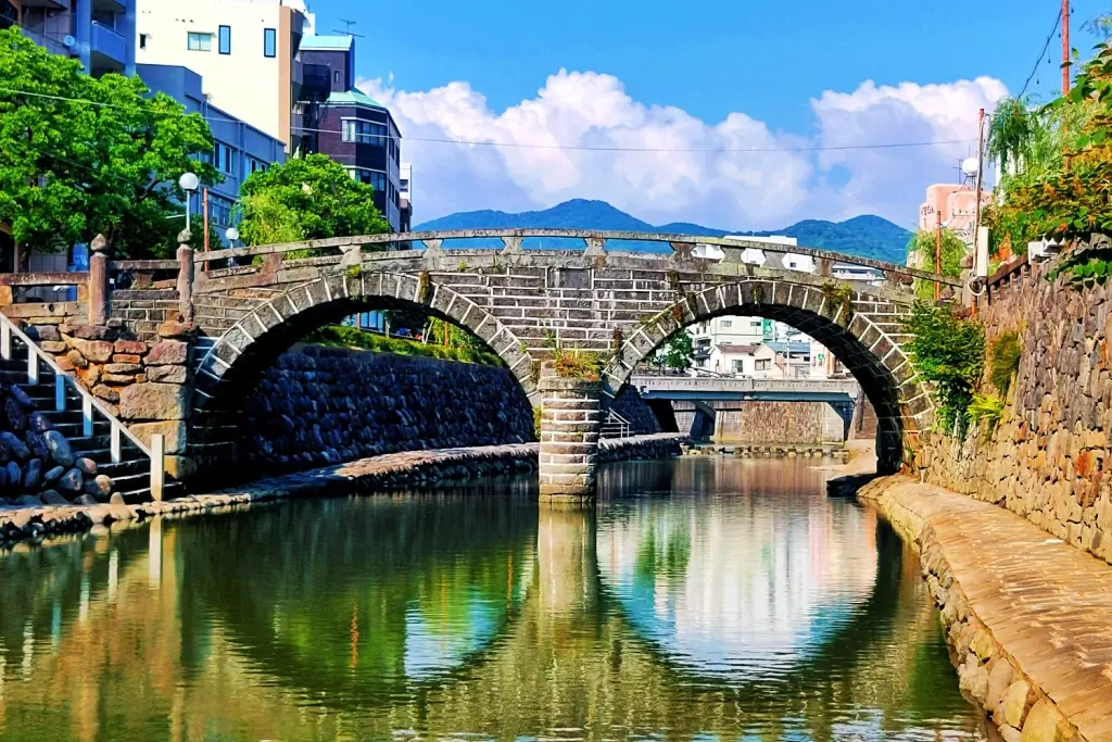 Meganebashi Bridge in Nagasaki. The arches in the bridge are reflected in the water, which gives the illusion of glasses.