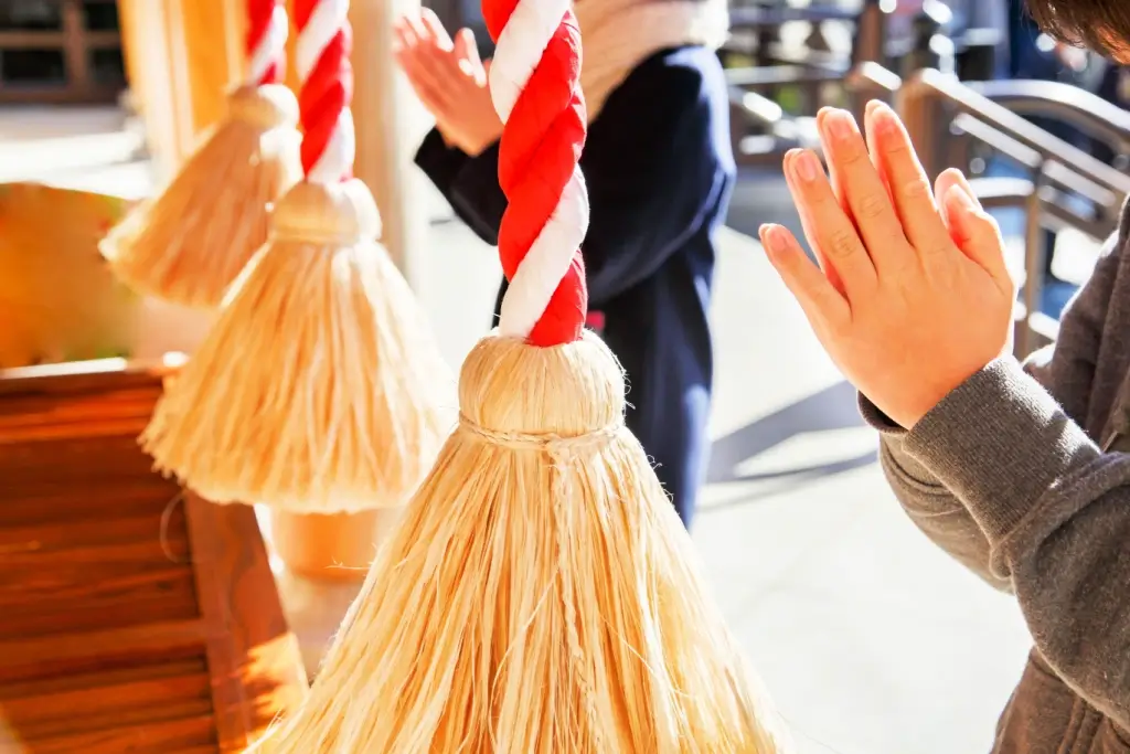 People praying at a shrine for New Year's in Japan.