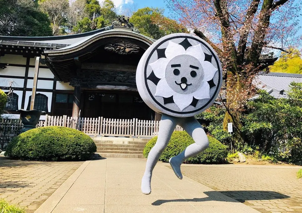 Nishiko dancing in front of a shrine at Nishi-Kokubunji Shrine. He is a tile mascot come to life.