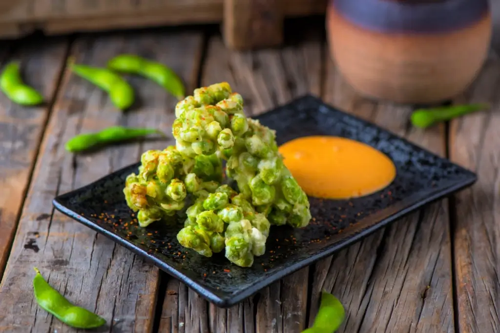 Edamame tempura on a plate.