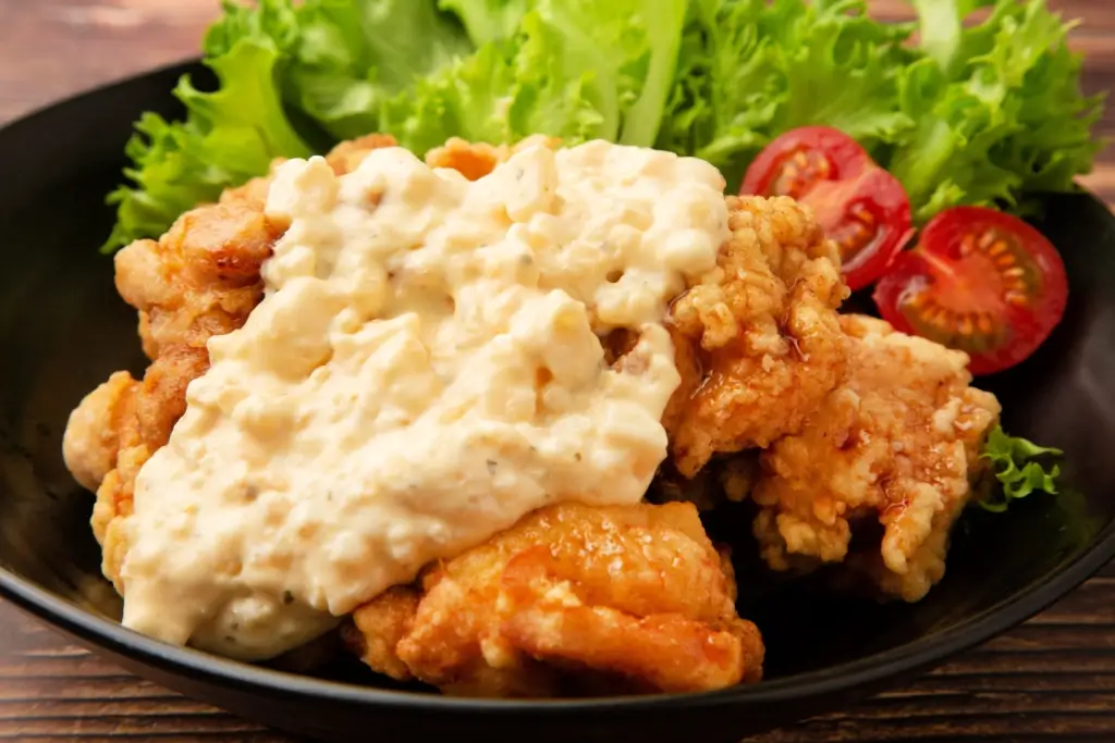 A chicken nanban platter. It features fried chicken and potato salad.