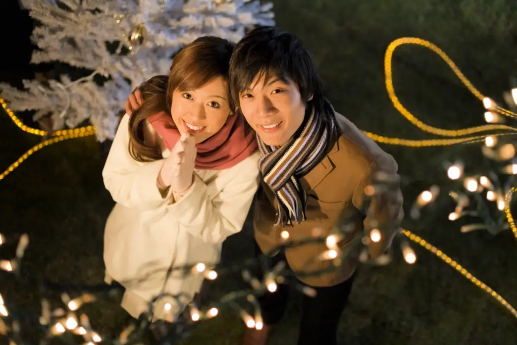 An couple looking up at the sky during Christmas in Japan.