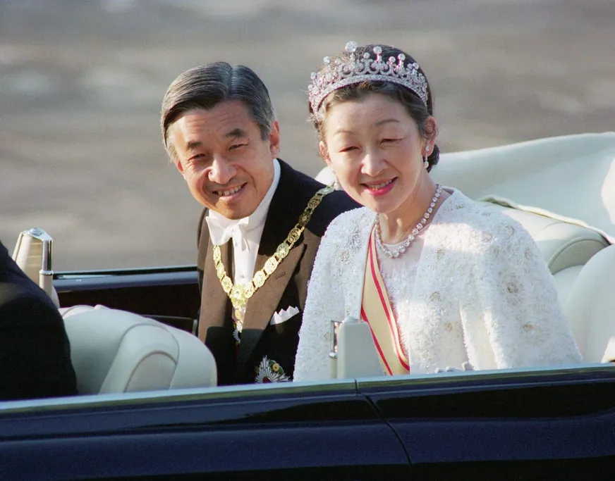 Emperor Akihito and Empress Michiko in their imperial car during the 1980s or 1990s.