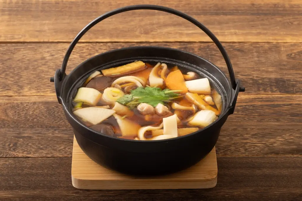 A big pot of hoto soup with big, flat noodles.