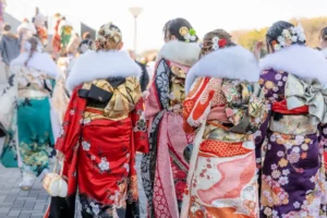 Young women in fancy kimonos wearing fur shrugs in Japan in January.