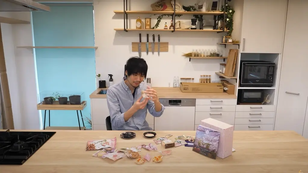 Jun from Jun's Kitchen slowly examining sakura mochi. 