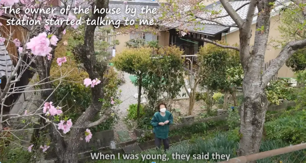 An elderly lady standing near the shop, as featured on Jun's Kitchen. 