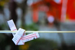 An omikuji (paper fortune) tied on a string.