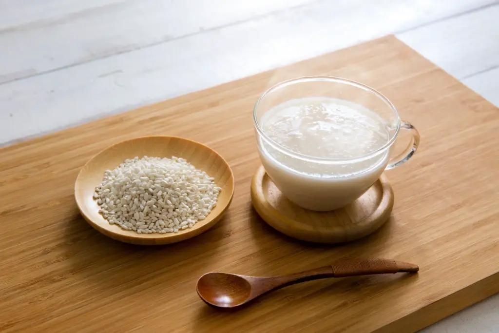 A plate of sake lees next to a glass of amazake.