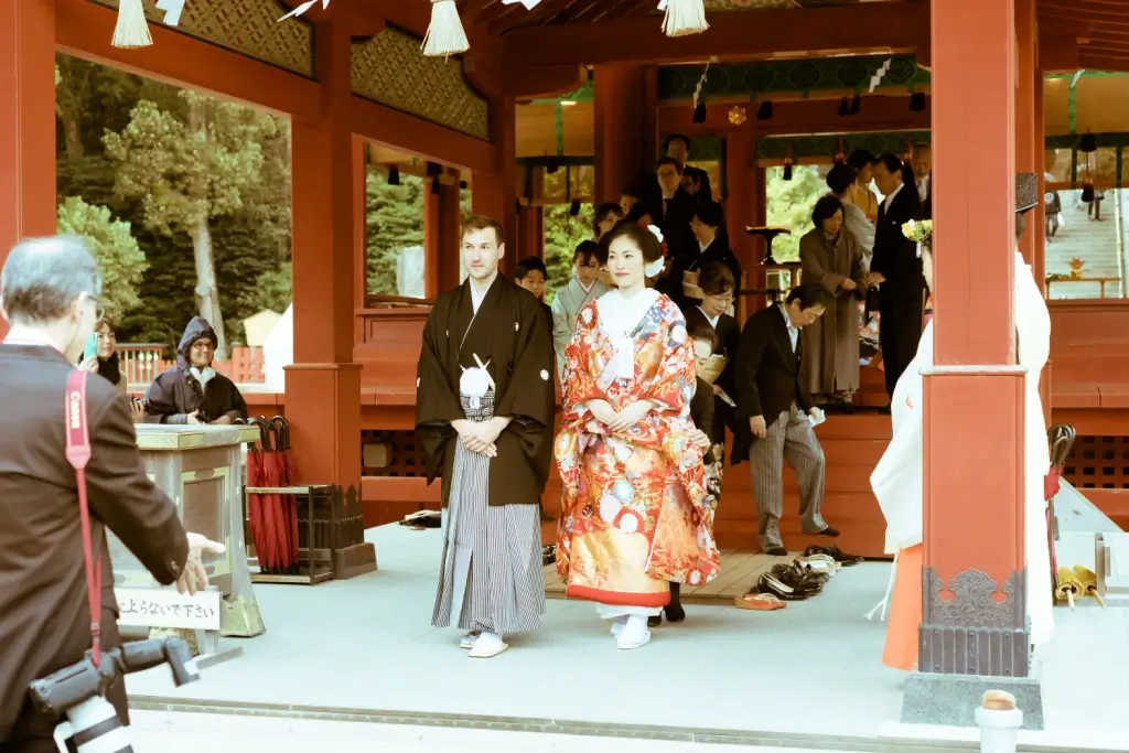 An interracial couple getting married at a Japanese wedding.