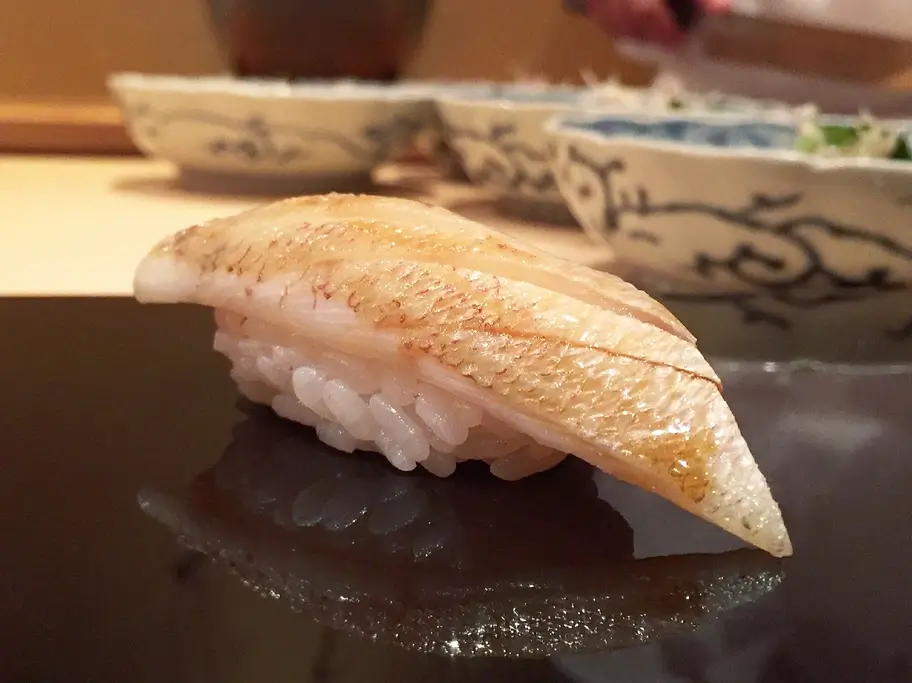 A piece of nigiri sushi from Harutaka.