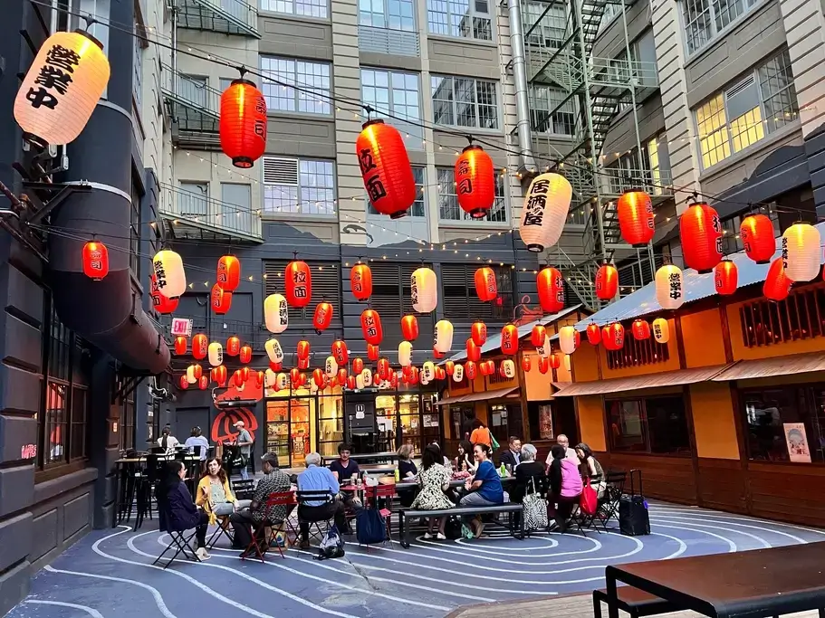 A bunch of Japanese lanterns surrounding a table in NYC.