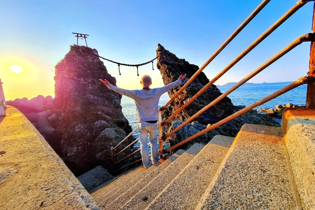 A person enjoying love rocks in Japan while standing on the stairs.