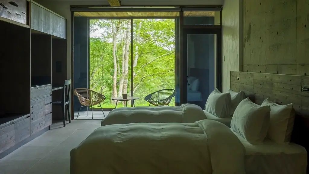 An earthy green bedroom at the Shiguchi Hotel.