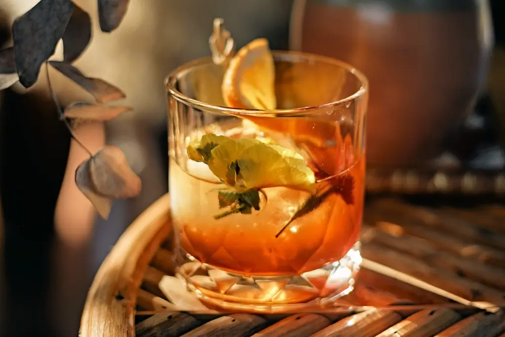 A glass of Japanese whiskey with flowers inside.