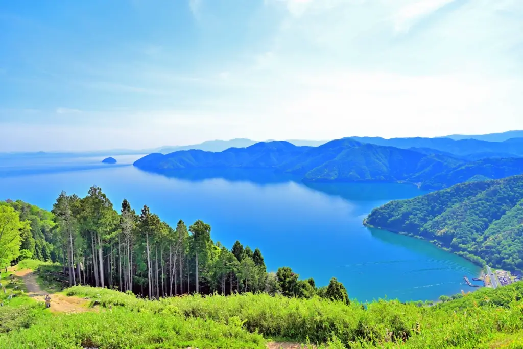 Lake Biwa during the day, surrounded by trees