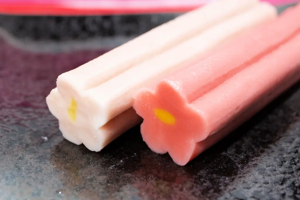 Two sticks of pink and white sticks of namafu.