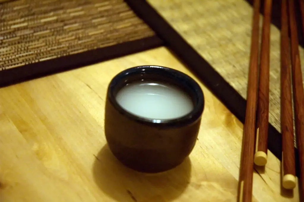 A black cup of nigori sake.