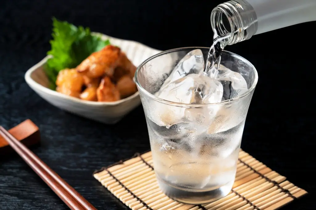 Someone pouring a glass of table sake.