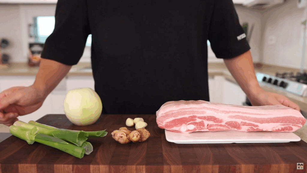 Aaron preparing ingredients for their Buta no Kakuni recipe in a home kitchen