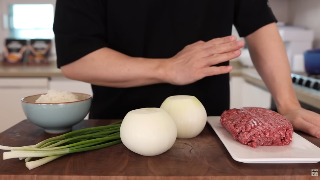 Aaron preparing ingredients for their Gyudon recipe in a home kitchen