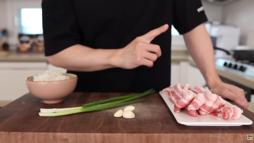 Aaron preparing ingredients for their Soy-Glazed Pork Belly Rice Bowl