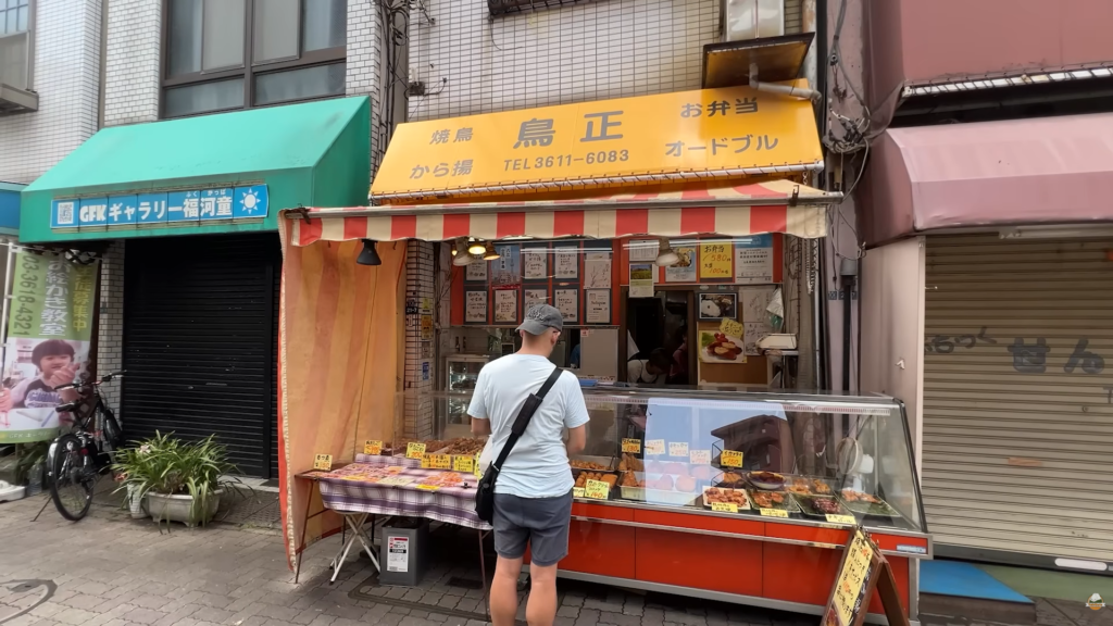 Satoshi choosing traditional Japanese bread at a local bakery