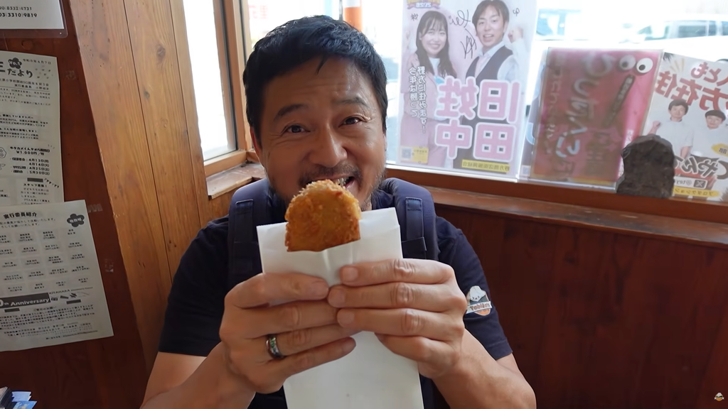 TabiEats' Shinichi trying korokke